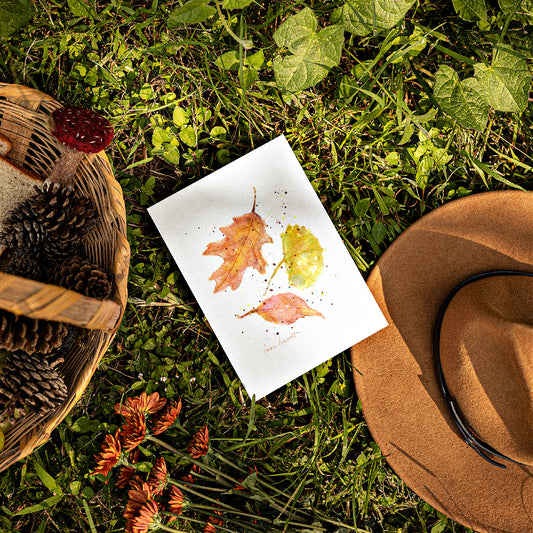 Mock up of our Autumn Leaves Card lying on the grass