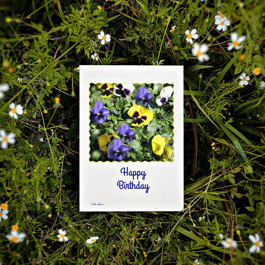 A photo of our Happy Birthday Card surround by flowers