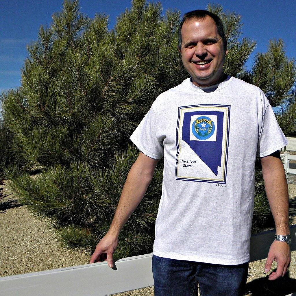 A smiling man wearing our Battle-Born Nevada T-shirt