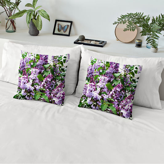 Mock up of two accent pillows  covered with our Lilacs Pillow Case against 2 white shams and a white duvet