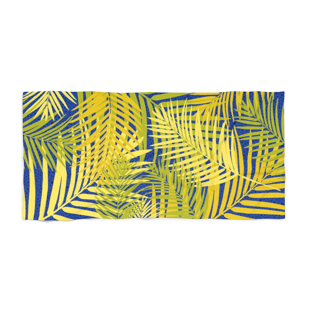 Flat front view of our beach towel featuring yellow palm fronds on a blue background
