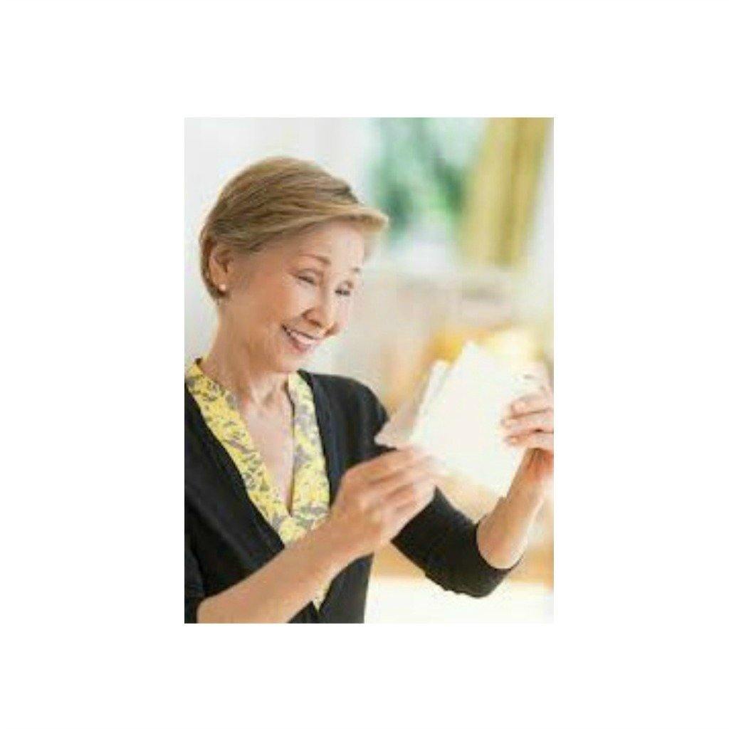 Smiling woman reading a greeting card