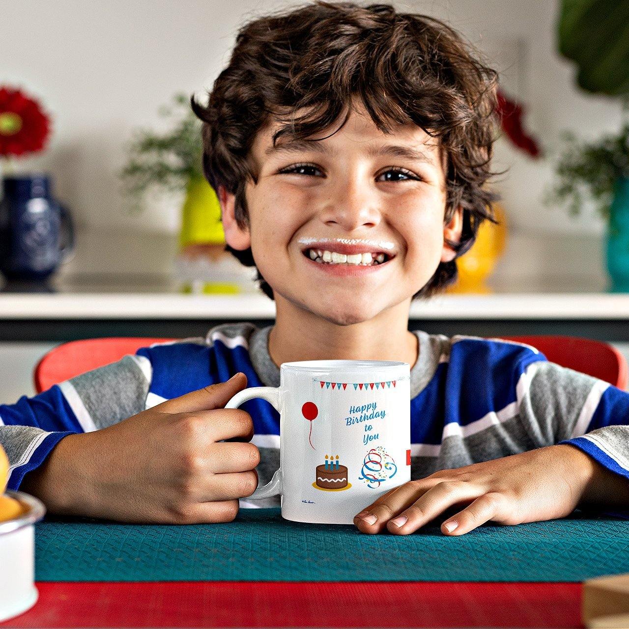 Mock up of a boy with a milk moustache holding our Birthday Celebration Mug