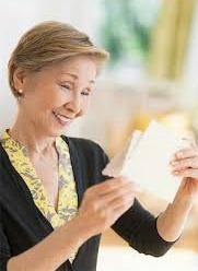Happy woman reading a greeting card