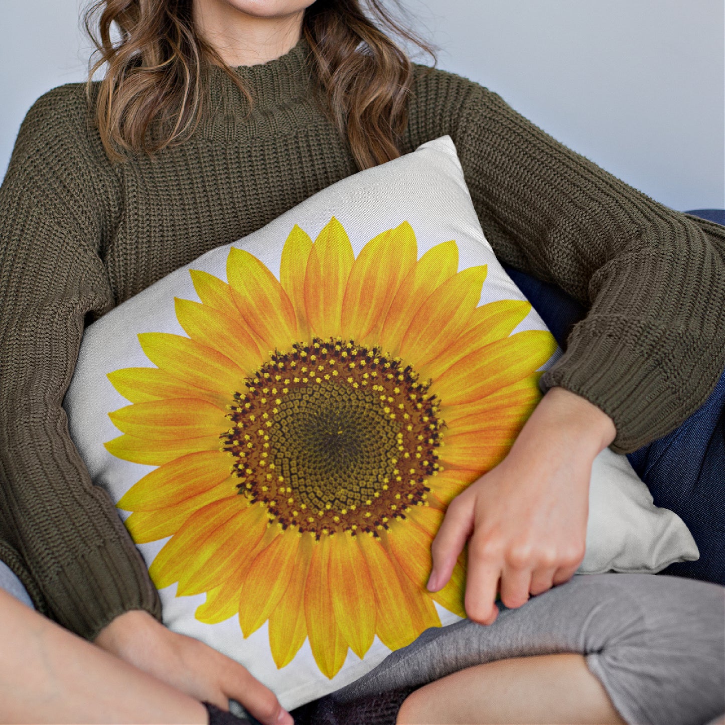 Mock up of a woman holding a square pillow covered with our Sunflower Pillow Case