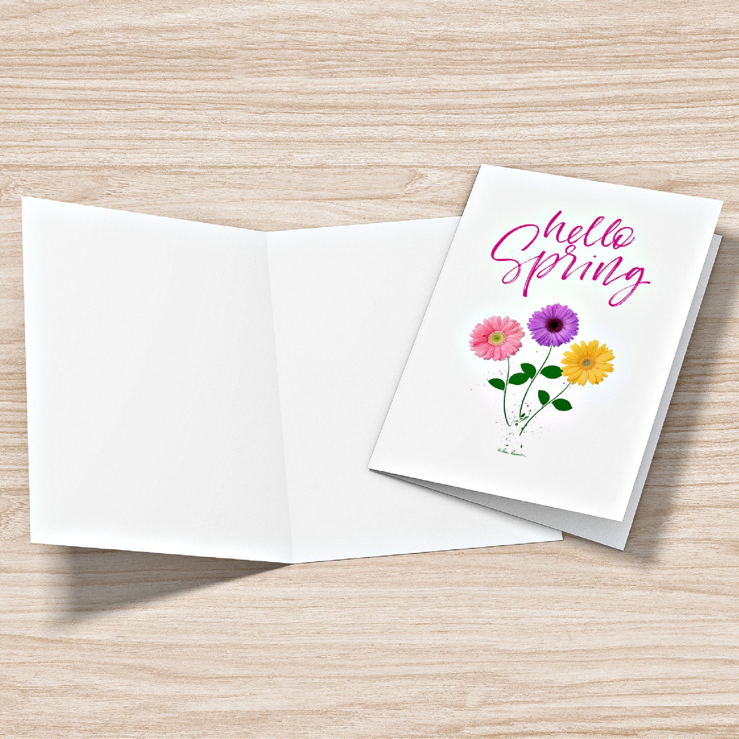 Mock up of our Hello-Spring Greeting Card; one lying open and another showing the front of the card
