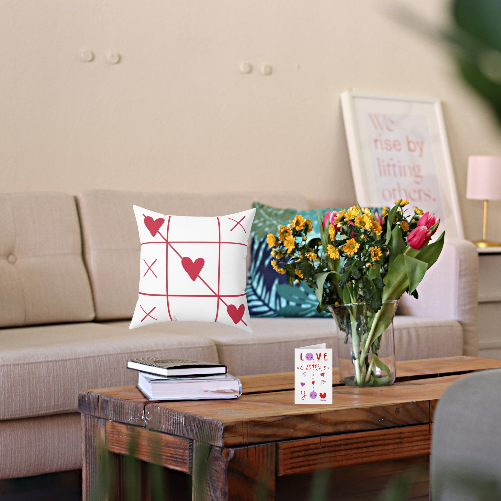 Mock up of our Valentine' Day Pillow on a sofa with flowers on a table in front