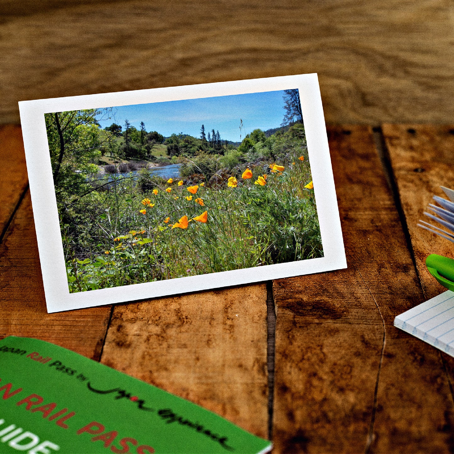 Mock up of our Orange Poppies Card on a wooden table