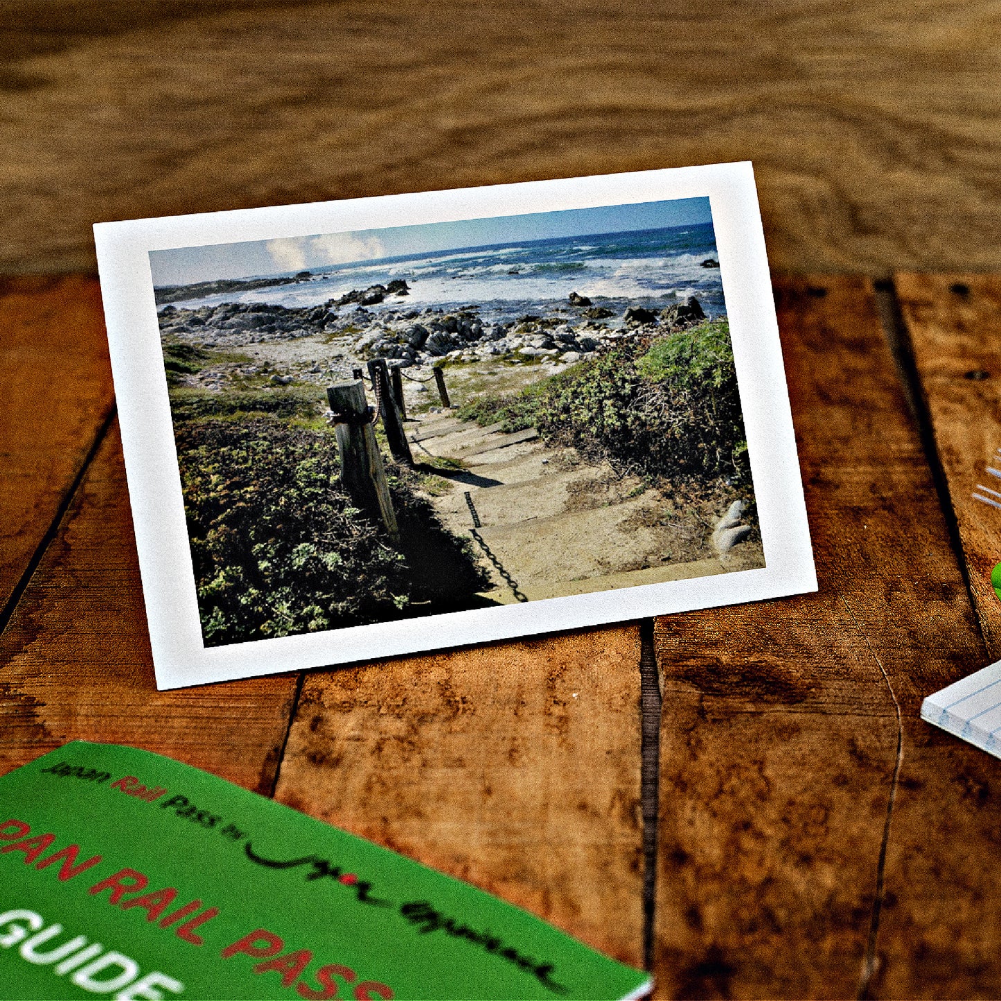 Mock up of our Seaside Greeting Card on a wooden table