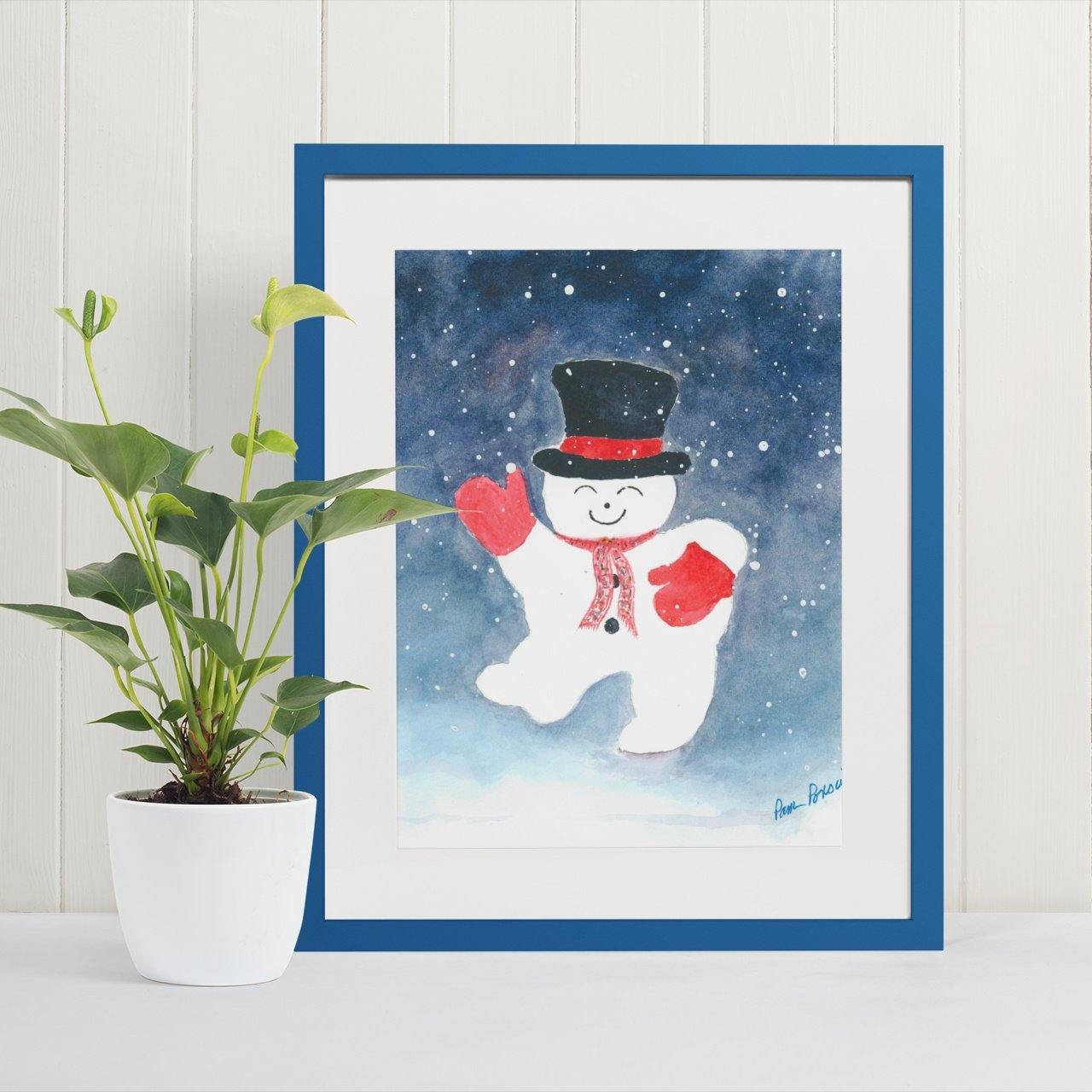 Mock up of our Snowman Watercolor Print when framed in a coordinating blue frame (not included)