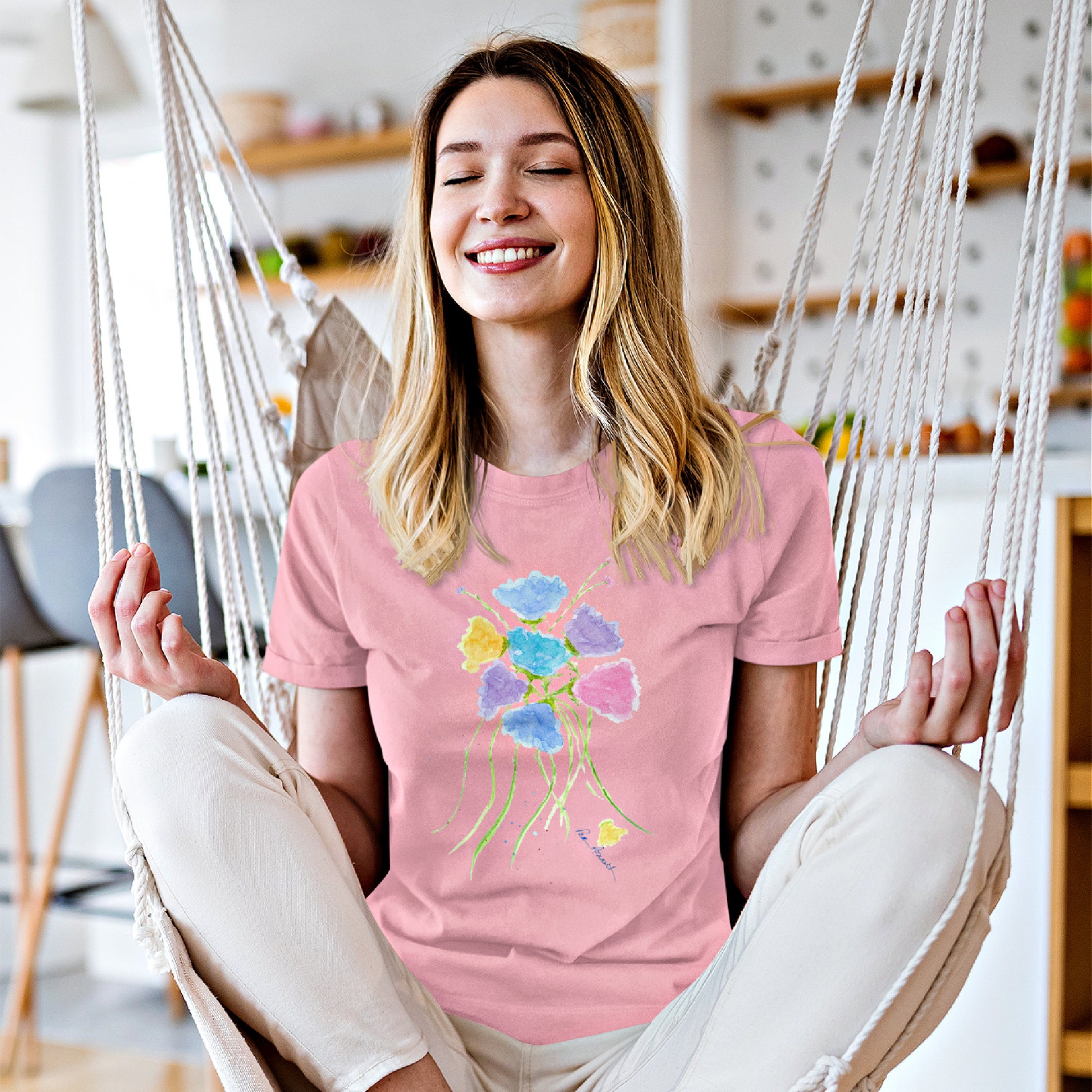 Mock up of a smiling woman who is meditating while wearing our Pink Watercolor-Flowers T-shirt