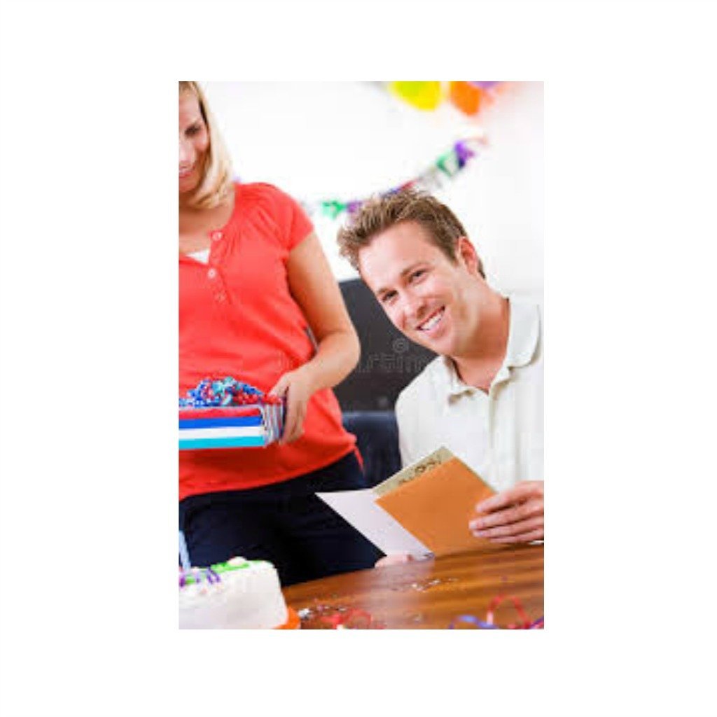 A smiling man reading a greeting card